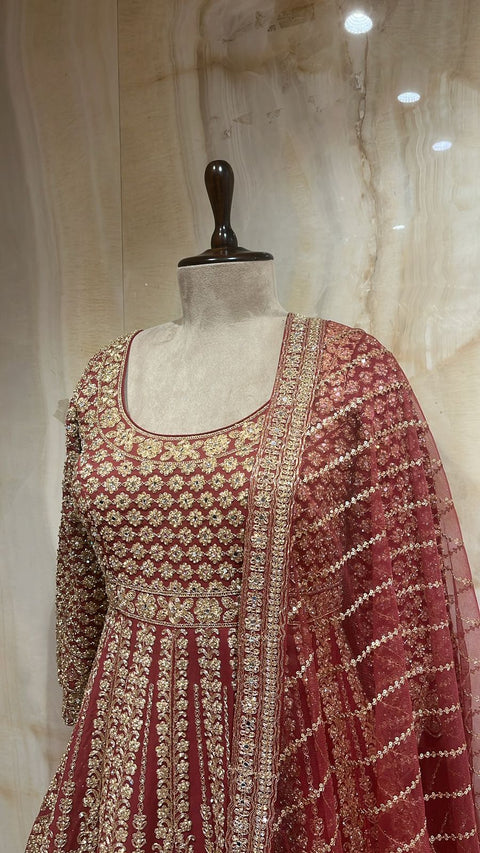 Sophisticated Rust Orange Lehnga Paired With Peplum Top & Net Dupatta