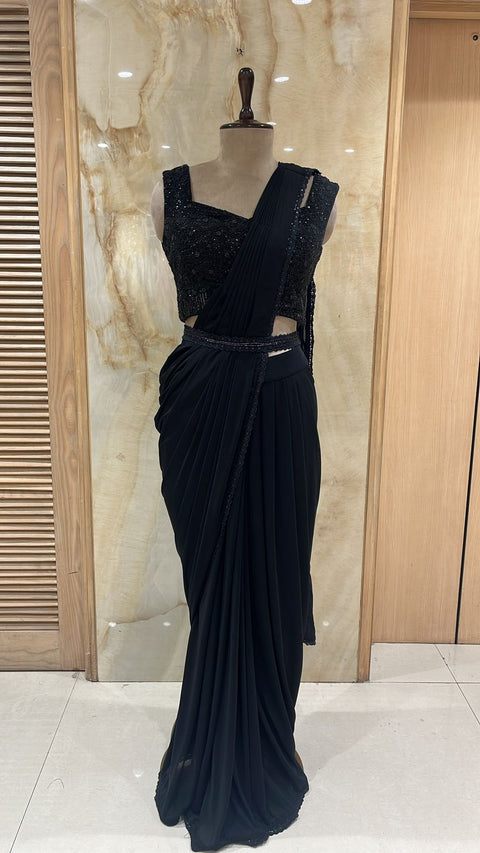 Timeless Black Pre- Drape Saree Paired With Matching Adorned Blouse.