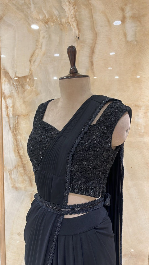 Timeless Black Pre- Drape Saree Paired With Matching Adorned Blouse.