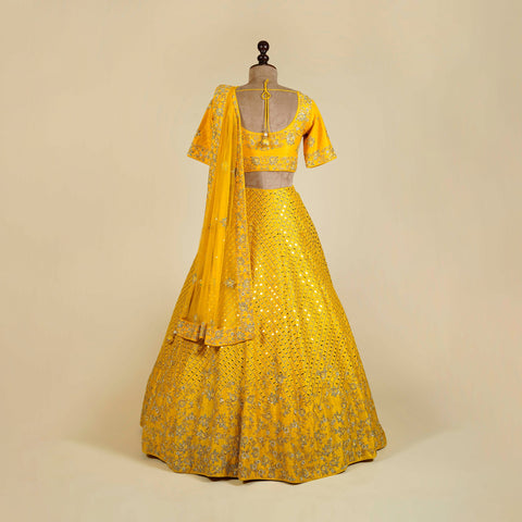 Yellow Lehenga Choli embellished with Mirror, Cut Dana and Pearl work