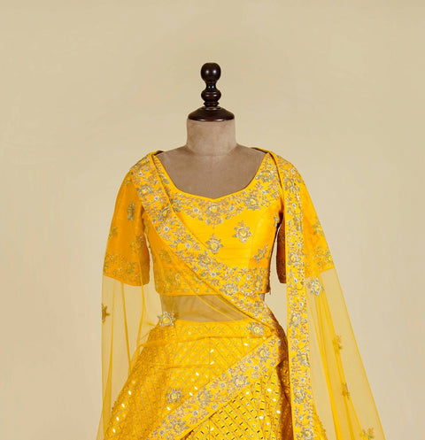 Yellow Lehenga Choli embellished with Mirror, Cut Dana and Pearl work