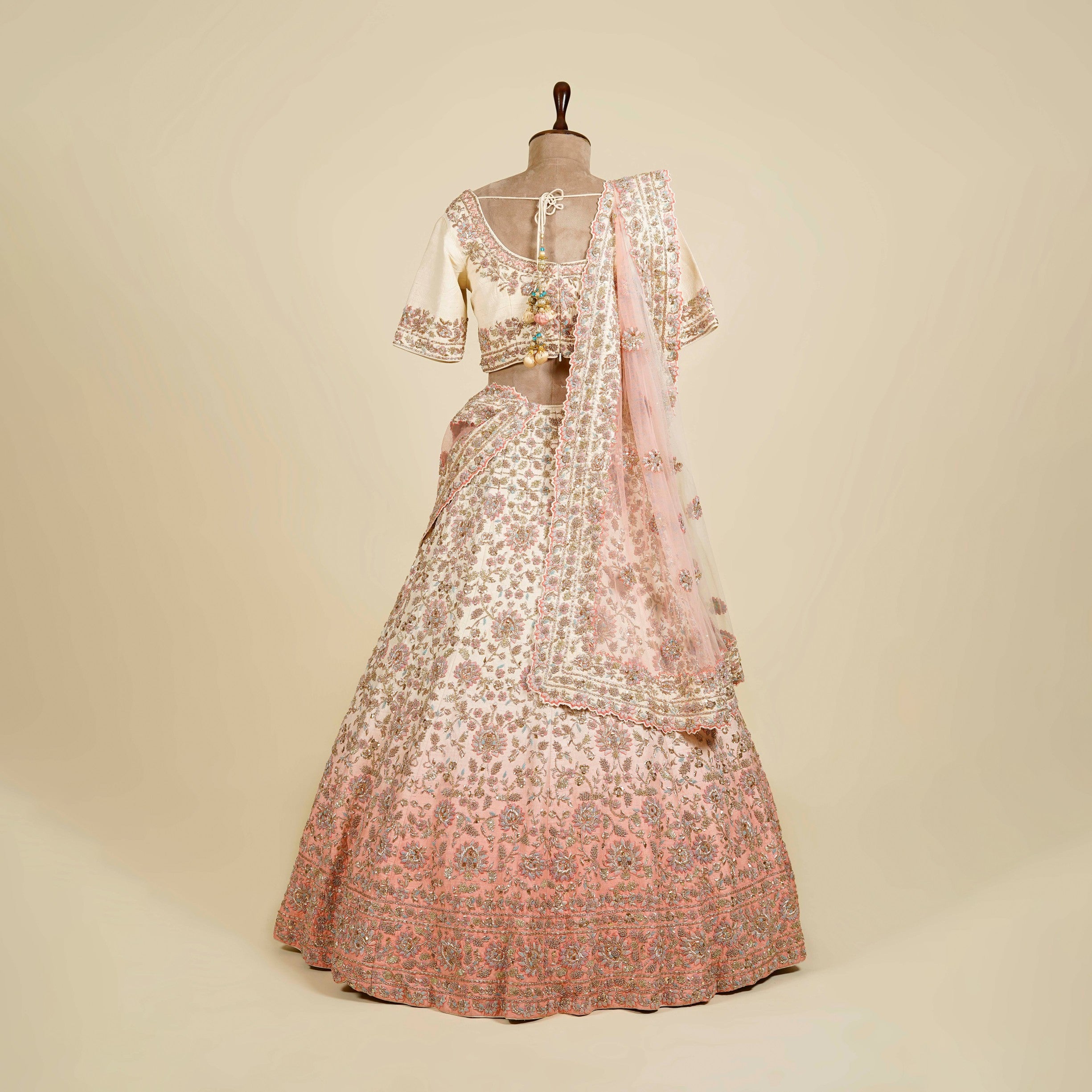 Ombre Cream-Peach Lehenga Choli embellished with Zardosi, Thread and Mukaish work